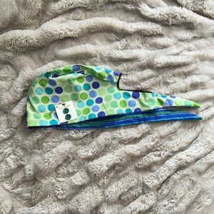Scrub cap w/ dotted fabric and green buttons.